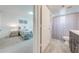 A view from a bedroom into the ensuite bathroom with wood-look flooring and modern vanity at 8708 Papaya Dr, Kissimmee, FL 34747