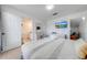 Bright bedroom featuring a television, ensuite bathroom, and comfortable furnishings at 8708 Papaya Dr, Kissimmee, FL 34747