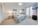 Comfortable bedroom featuring carpet, dresser with mirror, soft natural light and television at 8708 Papaya Dr, Kissimmee, FL 34747