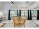 Dining area features a glass table, wicker chairs, and views of the screened-in porch at 8708 Papaya Dr, Kissimmee, FL 34747