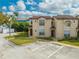 Inviting condo exterior with tidy landscaping, clearly marked parking, and classic tile roofing at 8708 Papaya Dr, Kissimmee, FL 34747
