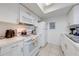Functional kitchen with white cabinetry, standard appliances, and efficient layout at 8708 Papaya Dr, Kissimmee, FL 34747