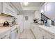 Well-lit kitchen featuring white appliances, tile flooring, and ample countertop space at 8708 Papaya Dr, Kissimmee, FL 34747