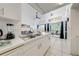 Bright kitchen features white cabinetry and appliances, flowing into the dining and living area at 8708 Papaya Dr, Kissimmee, FL 34747