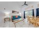 Bright living room featuring neutral tile floors, stylish furnishings, ceiling fan, and sliding glass doors at 8708 Papaya Dr, Kissimmee, FL 34747