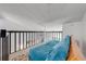 Bright loft featuring modern railing and neutral carpet offering a versatile space within the home at 8708 Papaya Dr, Kissimmee, FL 34747