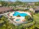 Beautiful community pool area featuring lounge chairs, lush landscaping, and a soothing hot tub at 8708 Papaya Dr, Kissimmee, FL 34747