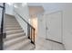 Clean staircase with neutral carpet and modern railing, leading to the upper level at 8708 Papaya Dr, Kissimmee, FL 34747