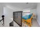 Staircase featuring an open loft area with a futon for additional living space at 8708 Papaya Dr, Kissimmee, FL 34747