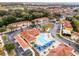 Aerial view of community pool with palm trees, lounge chairs, and a nearby playground at 1007 Park Ridge Cir, Kissimmee, FL 34746