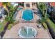 Aerial view of a pool and splashpad with chairs, part of a colorful resort-style community at 1007 Park Ridge Cir, Kissimmee, FL 34746