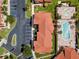 Aerial view of the community, featuring a red-roofed building, parking lot, and community pool at 1007 Park Ridge Cir, Kissimmee, FL 34746