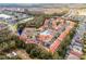 Aerial view of a condo community with a pool, lush landscaping, and a well-maintained exterior at 1007 Park Ridge Cir, Kissimmee, FL 34746