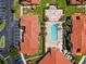 Overhead view of a beautiful community featuring pool, splashpad, red roofs, parking and lush landscaping at 1007 Park Ridge Cir, Kissimmee, FL 34746