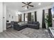 Modern living room featuring a comfortable sofa, stylish rug, and large windows for natural light at 1007 Park Ridge Cir, Kissimmee, FL 34746