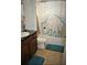 This bathroom offers a shower and tub combination, a large mirror, and a cute buffalo-themed shower curtain at 10467 Henbury St, Orlando, FL 32832