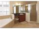 Bright bathroom features a shower, tub, neutral tile, and a vanity area at 10467 Henbury St, Orlando, FL 32832