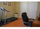 This office space features a treadmill, desk area, and hardwood floors at 10467 Henbury St, Orlando, FL 32832