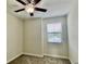 Cozy carpeted bedroom featuring a ceiling fan and a bright window, perfect for a tranquil living space at 1258 Royal St George Blvd, Davenport, FL 33896