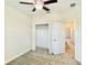 Bedroom with a ceiling fan, an open closet, and an adjacent doorway at 1258 Royal St George Blvd, Davenport, FL 33896