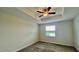 Inviting bedroom with plush carpeting, soft neutral walls, fan, and a sunny window, creating a relaxing retreat at 1258 Royal St George Blvd, Davenport, FL 33896