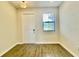 Light-filled entryway boasting wood-look flooring and a white front door at 1258 Royal St George Blvd, Davenport, FL 33896