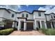 Charming townhome featuring a well-maintained front yard and a brick driveway at 1258 Royal St George Blvd, Davenport, FL 33896
