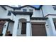 Close-up of a townhome showcasing its arched entryway and garage at 1258 Royal St George Blvd, Davenport, FL 33896