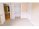 Neutral bedroom with carpet, a closet, and two doorways at 12634 Ringwood Ave, Orlando, FL 32837