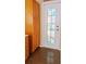 Hallway with wood cabinet and a white door with decorative glass panel at 12634 Ringwood Ave, Orlando, FL 32837