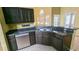 View of the kitchen featuring dark cabinets and neutral countertops at 12634 Ringwood Ave, Orlando, FL 32837