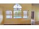 Bright living room with hardwood floors and large windows overlooking the pool area at 12634 Ringwood Ave, Orlando, FL 32837