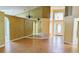 Bright living room with hardwood floors, mirror accent wall, and arched doorway at 12634 Ringwood Ave, Orlando, FL 32837