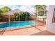 Sparkling swimming pool surrounded by a safety fence and colorful landscaping at 12634 Ringwood Ave, Orlando, FL 32837