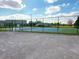 View of well-maintained outdoor tennis courts enclosed by a secure fence at 12634 Ringwood Ave, Orlando, FL 32837