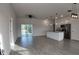 Bright open-concept living room and kitchen with gray wood-look tile and modern pendant lighting at 1313 Congo Dr, Kissimmee, FL 34759