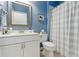 Bathroom with blue walls, a white vanity, and a shower curtain at 13258 Vennetta Way, Windermere, FL 34786