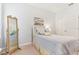 Bright bedroom featuring a beach-themed decor and a full-length mirror at 13258 Vennetta Way, Windermere, FL 34786