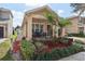 Charming single-story home with landscaped yard, inviting front porch, and cozy seating area at 13258 Vennetta Way, Windermere, FL 34786