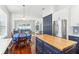 Bright kitchen featuring navy blue cabinets, butcher block island, and stainless steel appliances at 13258 Vennetta Way, Windermere, FL 34786