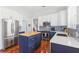 Kitchen featuring white countertops and cabinets, butcher block island, and stainless steel appliances at 13258 Vennetta Way, Windermere, FL 34786