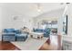 Bright living room with hardwood floors, comfortable blue furniture, and a sliding glass door at 13258 Vennetta Way, Windermere, FL 34786