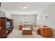 Cozy living room with neutral carpet, tv, and a comfortable plaid sofa at 13258 Vennetta Way, Windermere, FL 34786