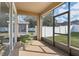 Enclosed patio featuring neutral flooring and a green bistro set with a view of the fenced yard at 13258 Vennetta Way, Windermere, FL 34786