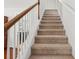 Carpeted staircase with white railings and natural wood trim at 13258 Vennetta Way, Windermere, FL 34786