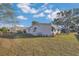 Backyard view of the home and the surrounding greenery at 145 Kensington Park Dr, Davenport, FL 33897