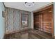 Simple bedroom with a closet, birch wallpaper, and wood-look flooring at 145 Kensington Park Dr, Davenport, FL 33897