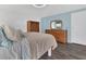 The bedroom features neutral bedding, a wood dresser, and stylish light fixtures at 145 Kensington Park Dr, Davenport, FL 33897