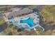 Aerial view of a community pool with tables and chairs, surrounded by palm trees at 145 Kensington Park Dr, Davenport, FL 33897