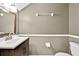 A bathroom with a dark wood vanity and gray walls at 1518 Orrington Payne Pl, Casselberry, FL 32707